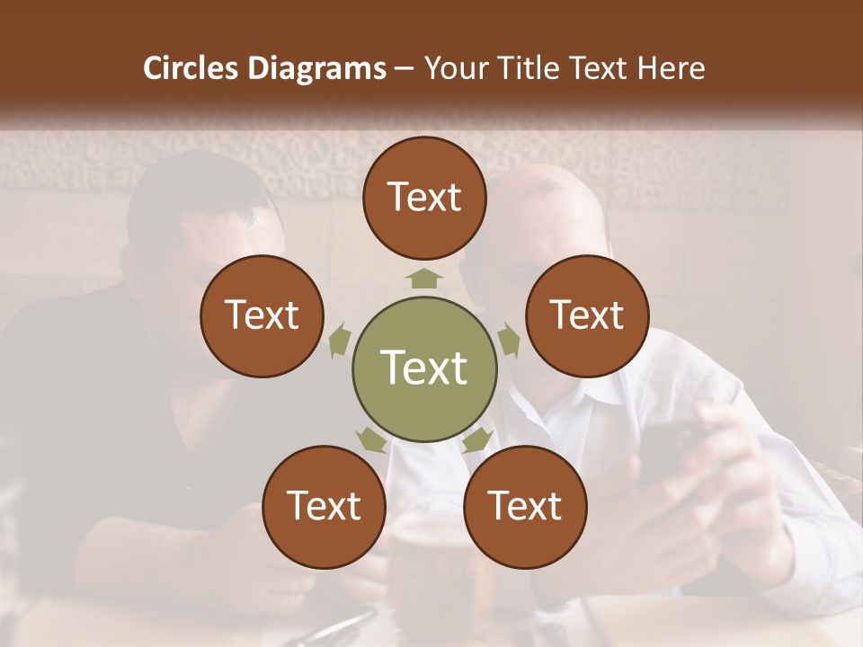 Two Men Sitting At A Table Looking At A Cell Phone PowerPoint Template