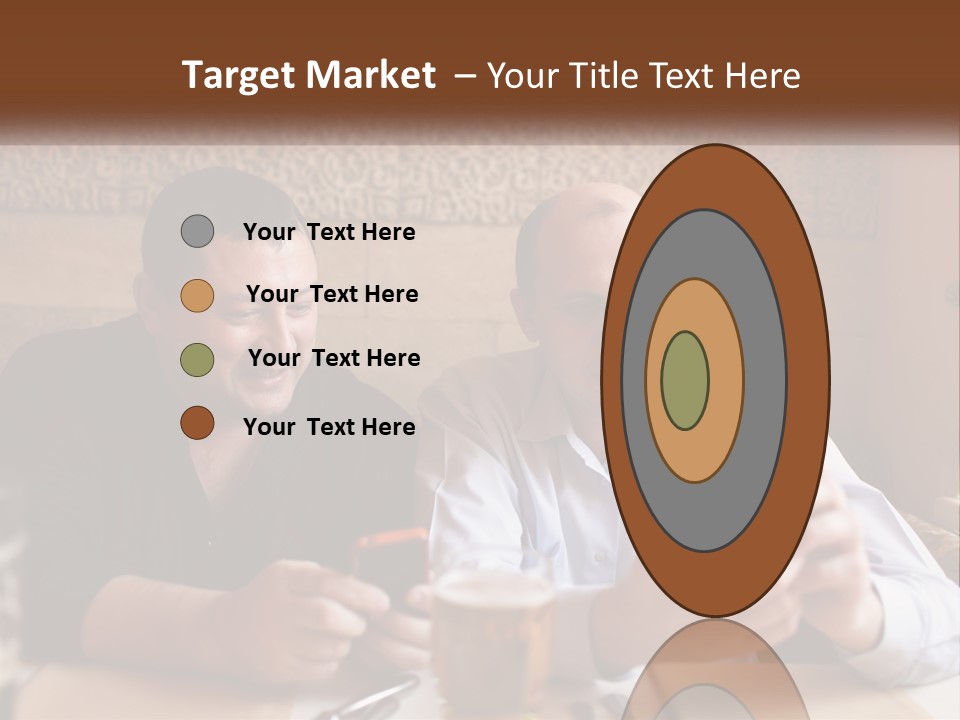 Two Men Sitting At A Table Looking At A Cell Phone PowerPoint Template