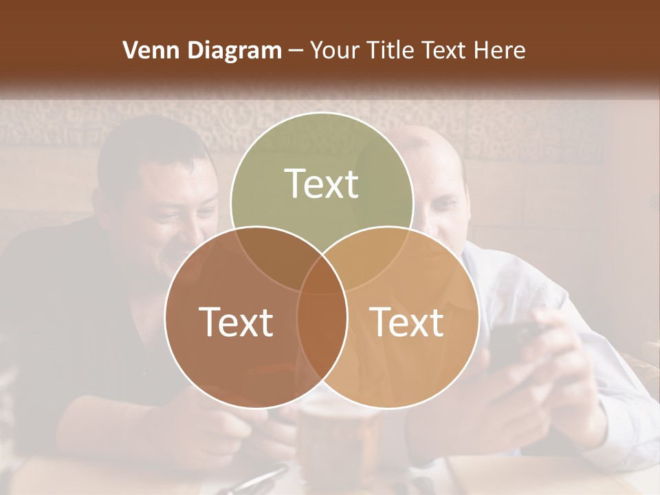 Two Men Sitting At A Table Looking At A Cell Phone PowerPoint Template