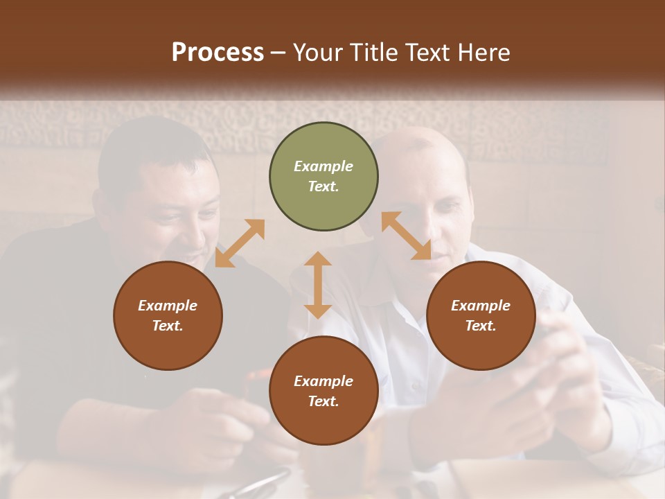 Two Men Sitting At A Table Looking At A Cell Phone PowerPoint Template
