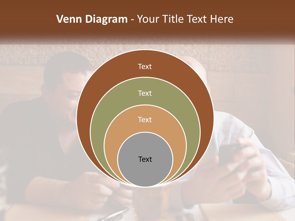 Two Men Sitting At A Table Looking At A Cell Phone PowerPoint Template