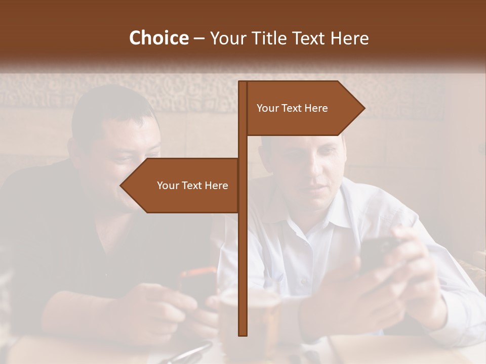 Two Men Sitting At A Table Looking At A Cell Phone PowerPoint Template