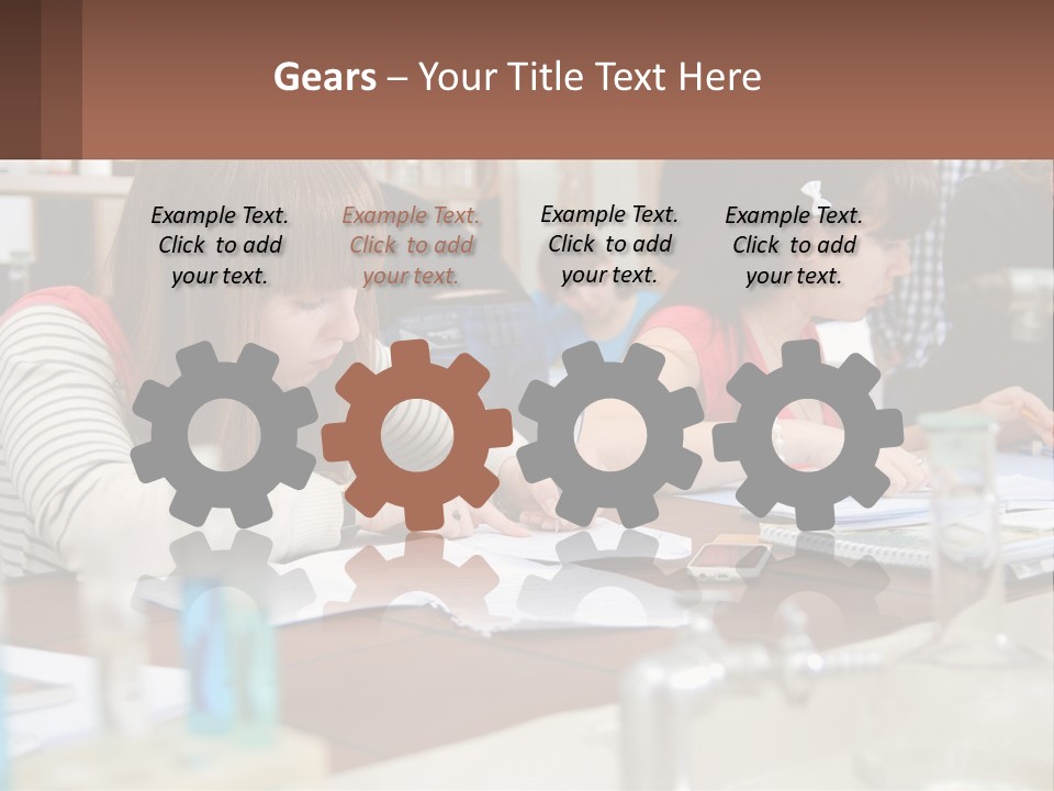 A Group Of People Sitting At A Table Writing PowerPoint Template