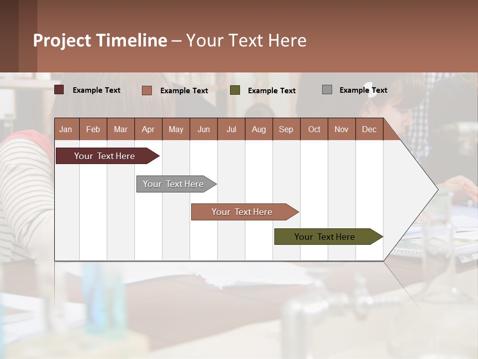 A Group Of People Sitting At A Table Writing PowerPoint Template