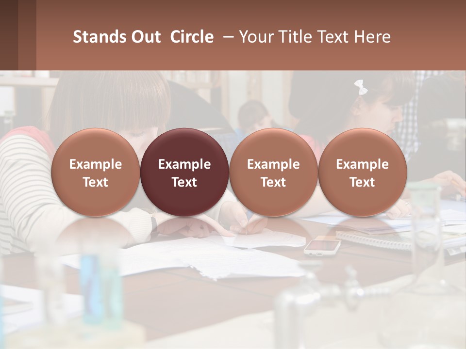 A Group Of People Sitting At A Table Writing PowerPoint Template