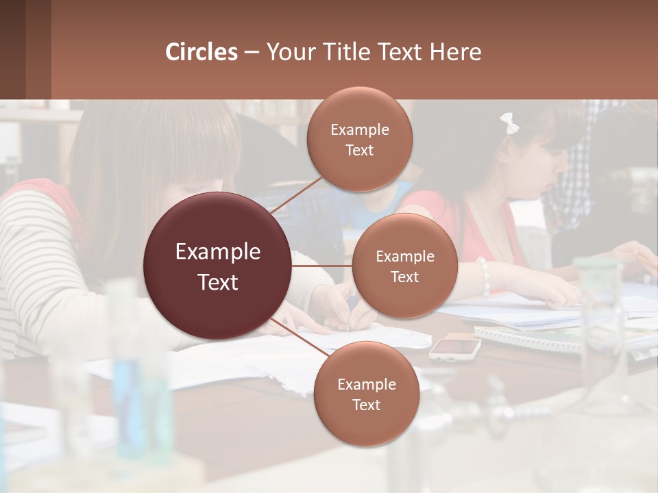 A Group Of People Sitting At A Table Writing PowerPoint Template