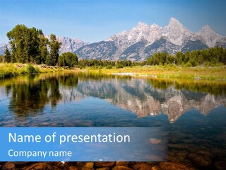 A Lake With Mountains In The Background PowerPoint Template