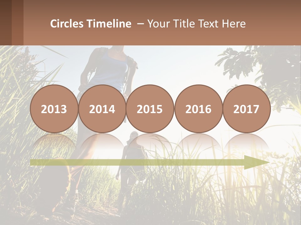 A Couple Of People Walking Through A Lush Green Field PowerPoint Template