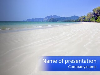 A Sandy Beach With Mountains In The Background PowerPoint Template