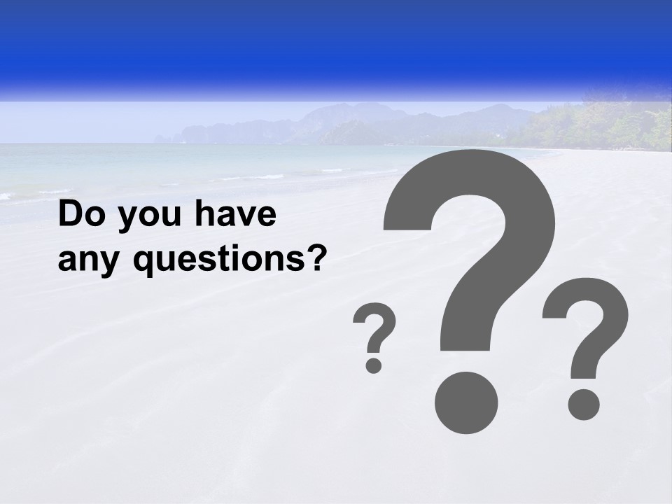 A Sandy Beach With Mountains In The Background PowerPoint Template