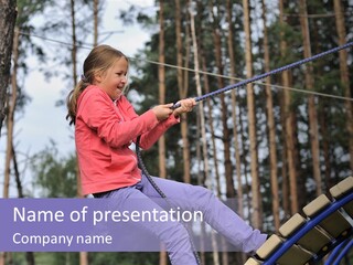 A Little Girl On A Rope In A Park PowerPoint Template