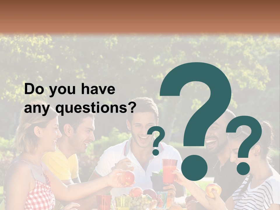 A Group Of People Sitting Around A Table With Food PowerPoint Template