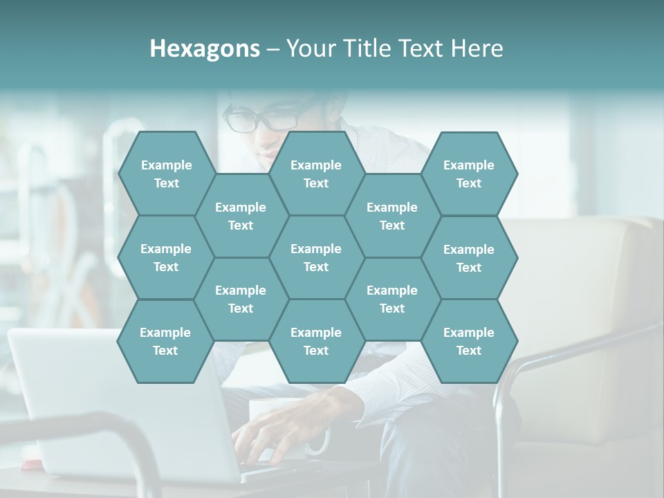 A Man Sitting At A Table Using A Laptop Computer PowerPoint Template