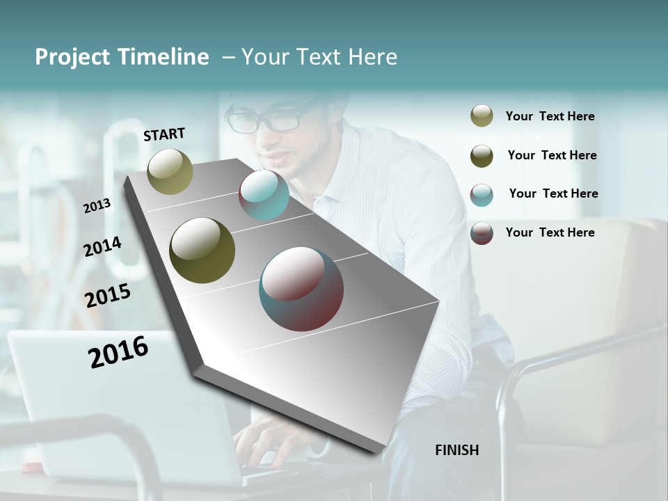 A Man Sitting At A Table Using A Laptop Computer PowerPoint Template