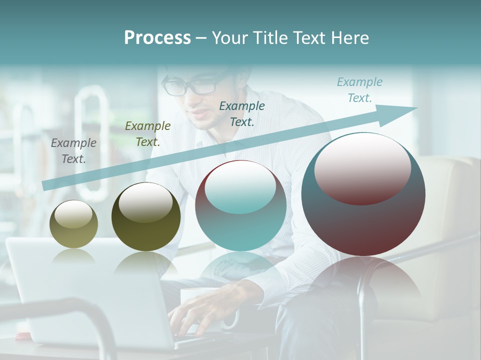 A Man Sitting At A Table Using A Laptop Computer PowerPoint Template