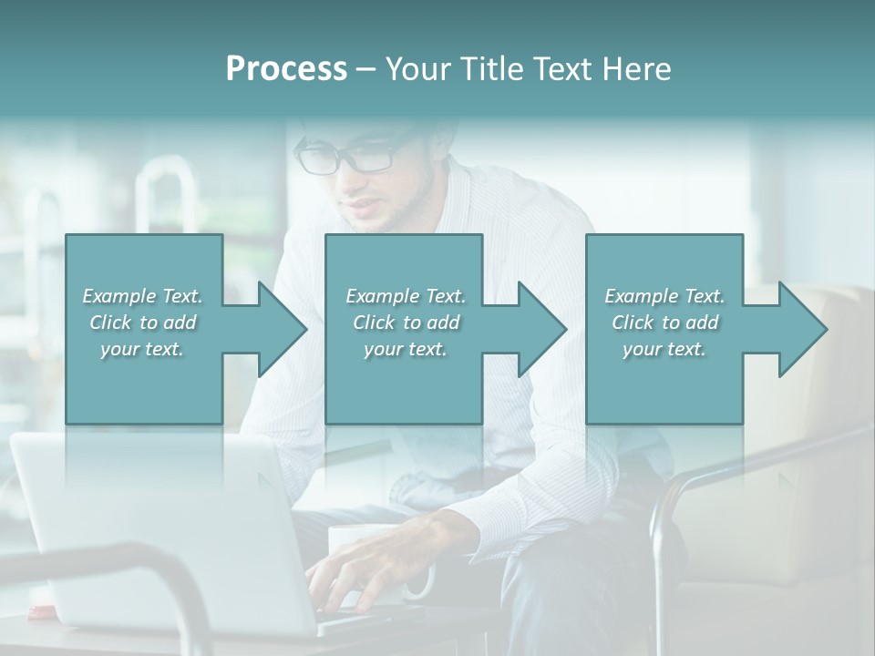 A Man Sitting At A Table Using A Laptop Computer PowerPoint Template