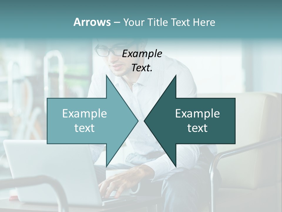 A Man Sitting At A Table Using A Laptop Computer PowerPoint Template