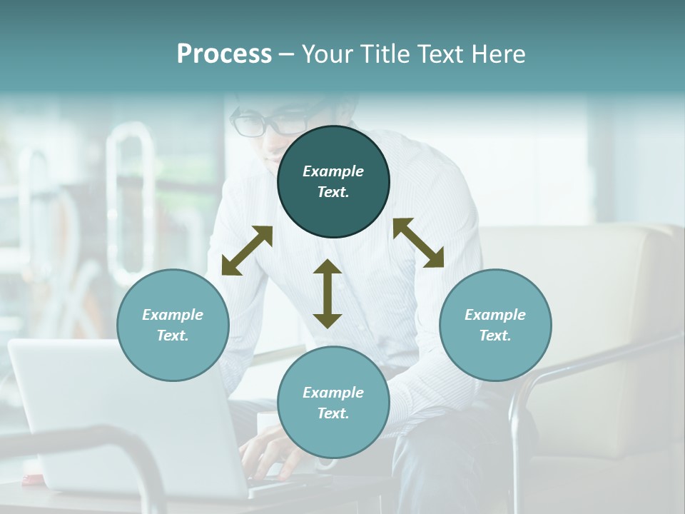A Man Sitting At A Table Using A Laptop Computer PowerPoint Template