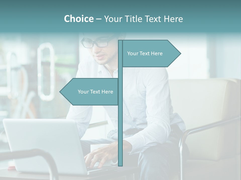 A Man Sitting At A Table Using A Laptop Computer PowerPoint Template