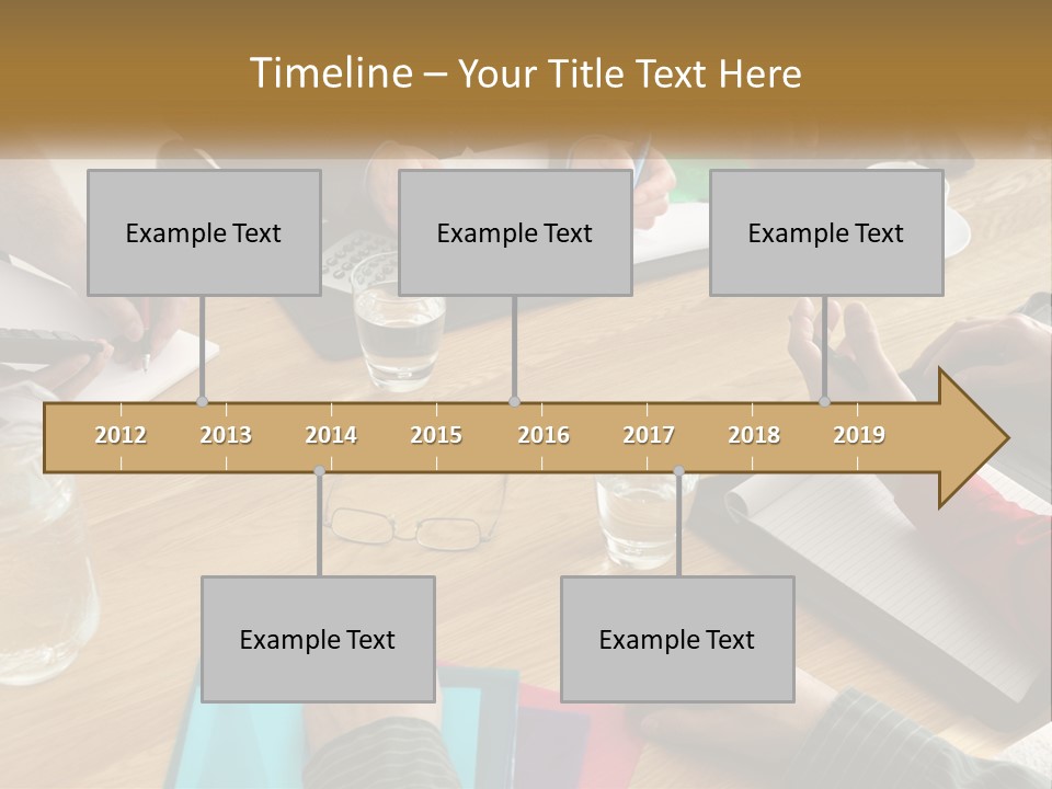 A Group Of People Sitting Around A Wooden Table PowerPoint Template