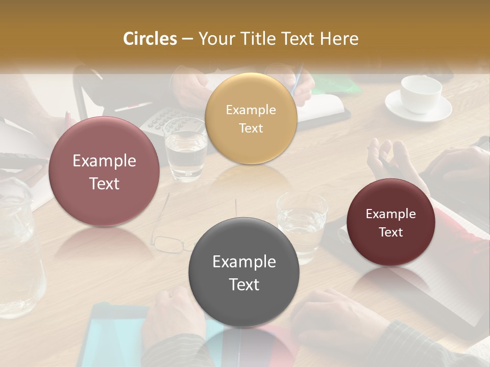 A Group Of People Sitting Around A Wooden Table PowerPoint Template