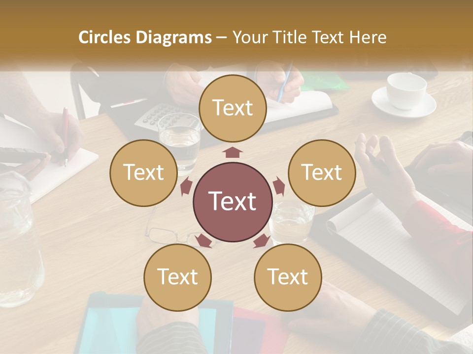 A Group Of People Sitting Around A Wooden Table PowerPoint Template