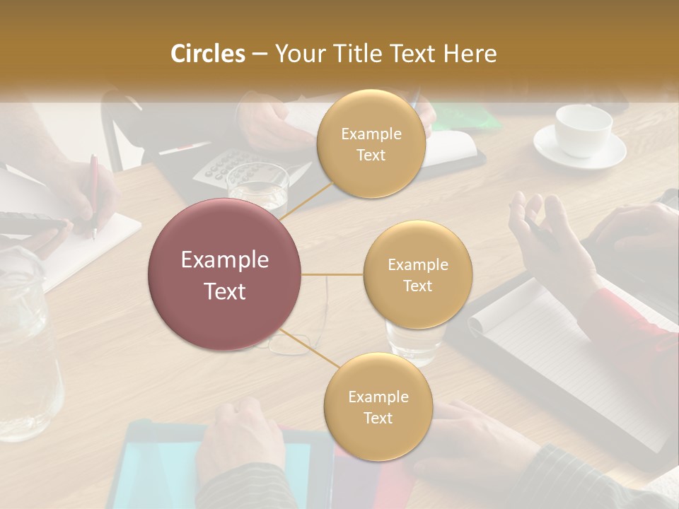 A Group Of People Sitting Around A Wooden Table PowerPoint Template