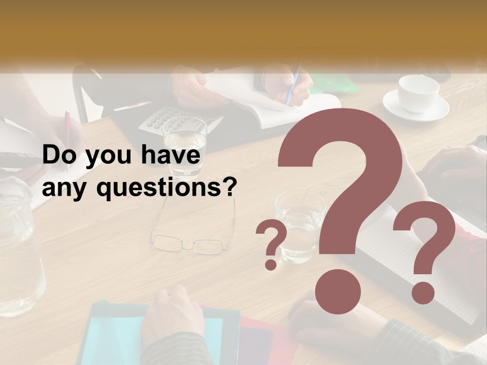 A Group Of People Sitting Around A Wooden Table PowerPoint Template