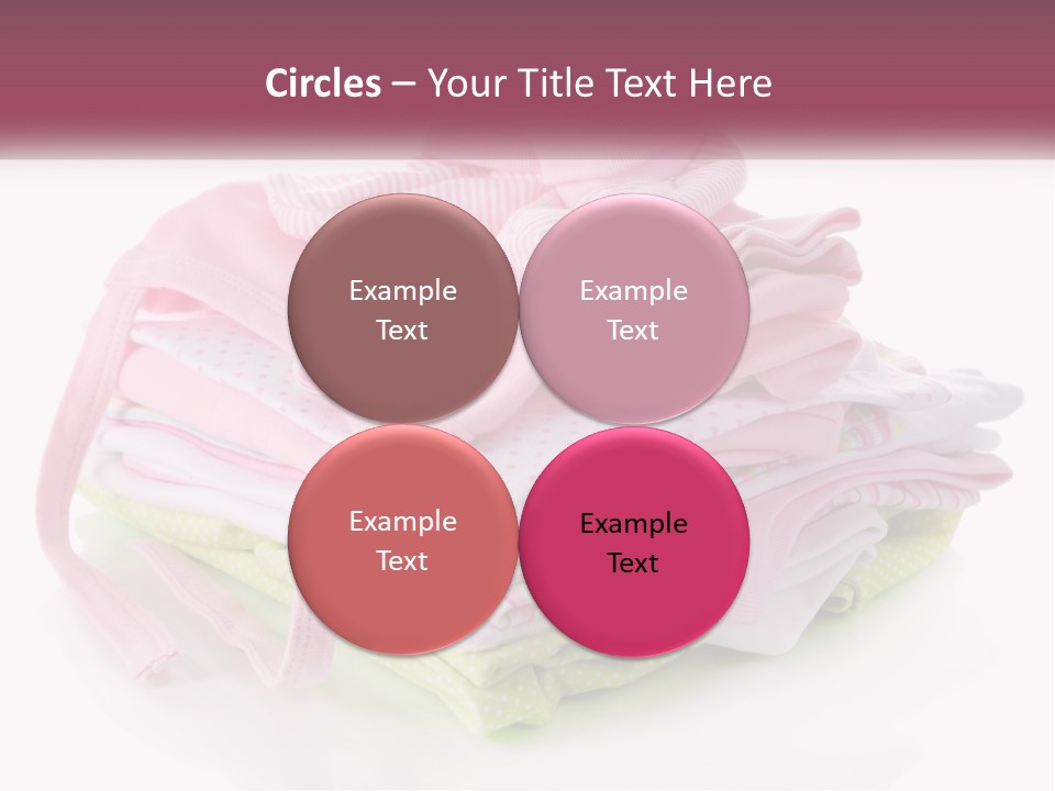 A Pile Of Baby Clothes With A Pacifier On Top Of It PowerPoint Template