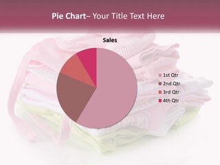 A Pile Of Baby Clothes With A Pacifier On Top Of It PowerPoint Template