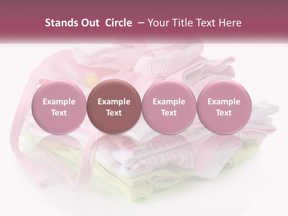 A Pile Of Baby Clothes With A Pacifier On Top Of It PowerPoint Template
