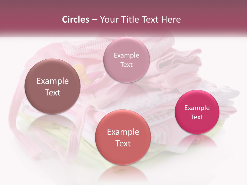 A Pile Of Baby Clothes With A Pacifier On Top Of It PowerPoint Template