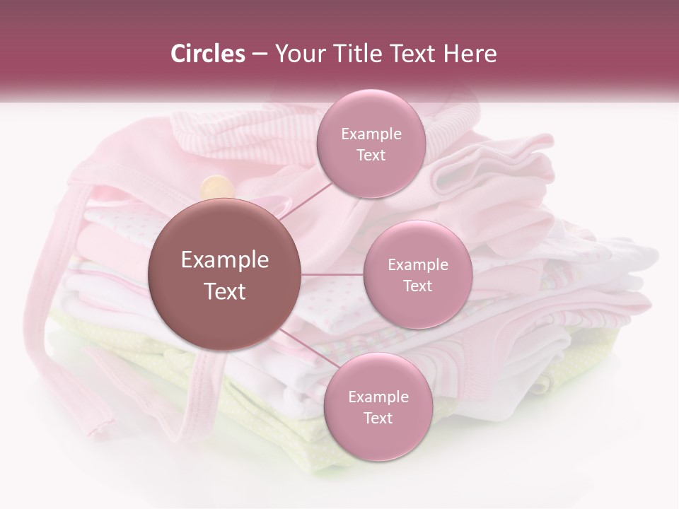 A Pile Of Baby Clothes With A Pacifier On Top Of It PowerPoint Template