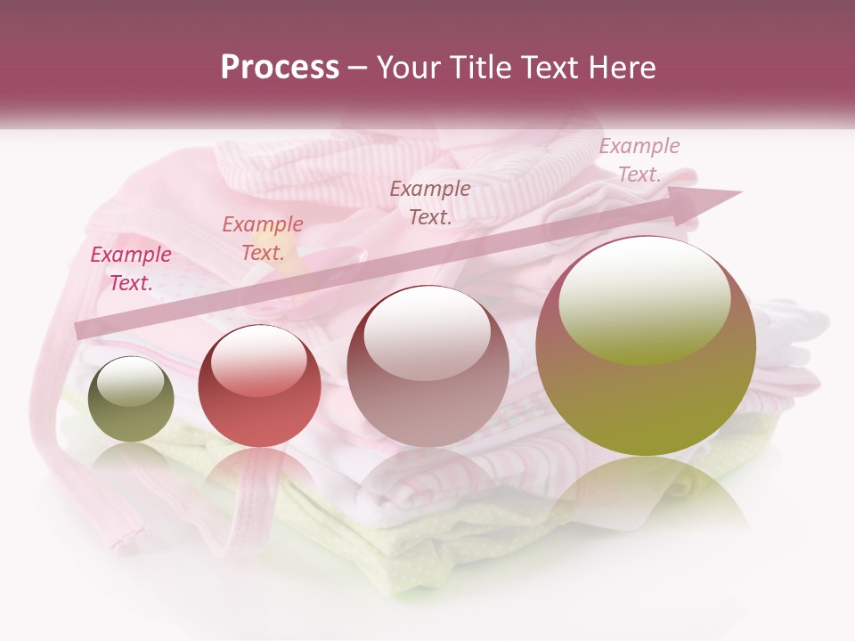 A Pile Of Baby Clothes With A Pacifier On Top Of It PowerPoint Template