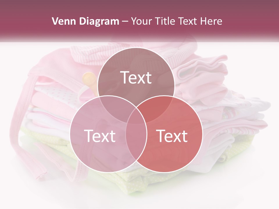 A Pile Of Baby Clothes With A Pacifier On Top Of It PowerPoint Template