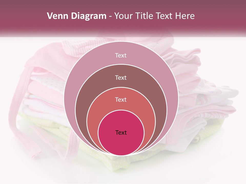 A Pile Of Baby Clothes With A Pacifier On Top Of It PowerPoint Template