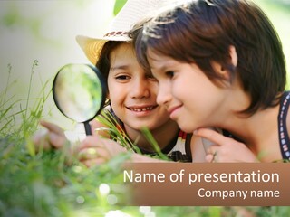 Two Children Looking Through A Magnifying Glass PowerPoint Template