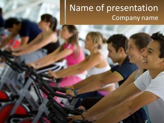 A Group Of People Riding Stationary Bikes In A Gym PowerPoint Template