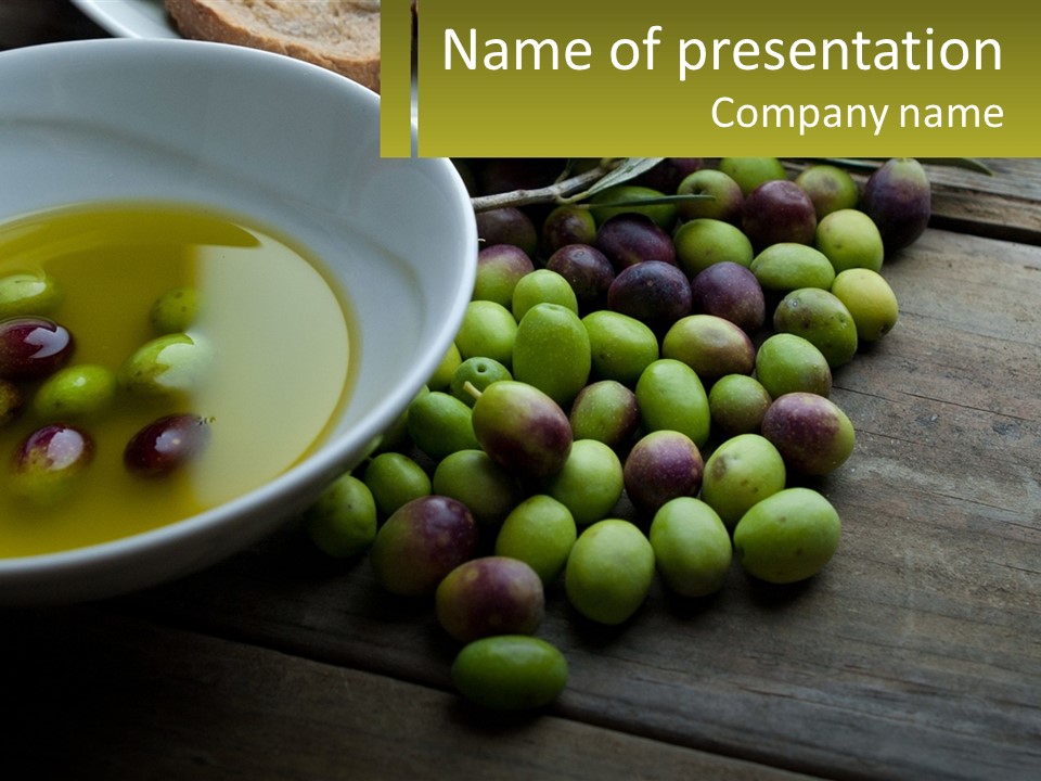 A Bowl Of Olives And Bread On A Table PowerPoint Template