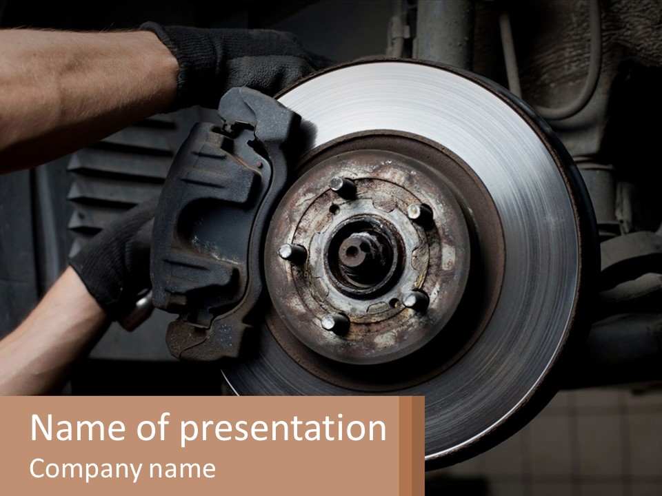A Man Is Changing A Brake On A Car PowerPoint Template