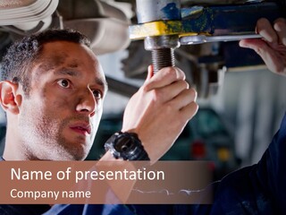 A Man Working On A Car In A Garage PowerPoint Template