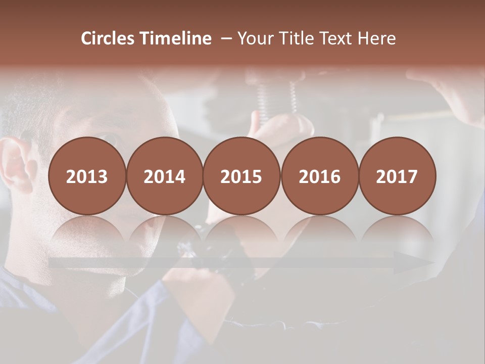 A Man Working On A Car In A Garage PowerPoint Template