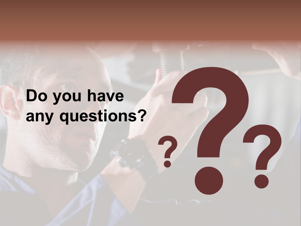 A Man Working On A Car In A Garage PowerPoint Template