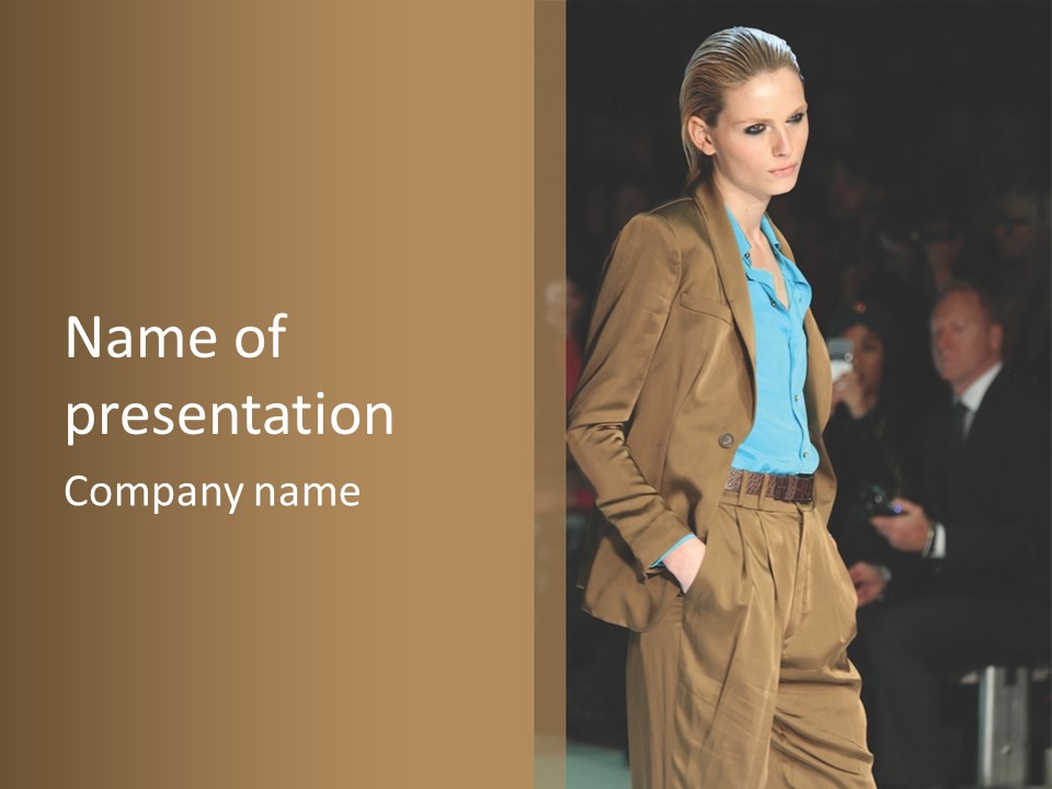 A Woman Walking Down A Runway In A Suit PowerPoint Template