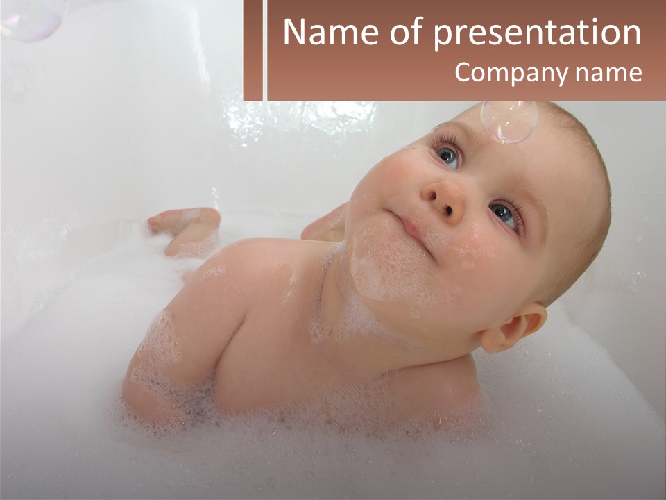 A Baby In A Bathtub With Bubbles Of Water PowerPoint Template