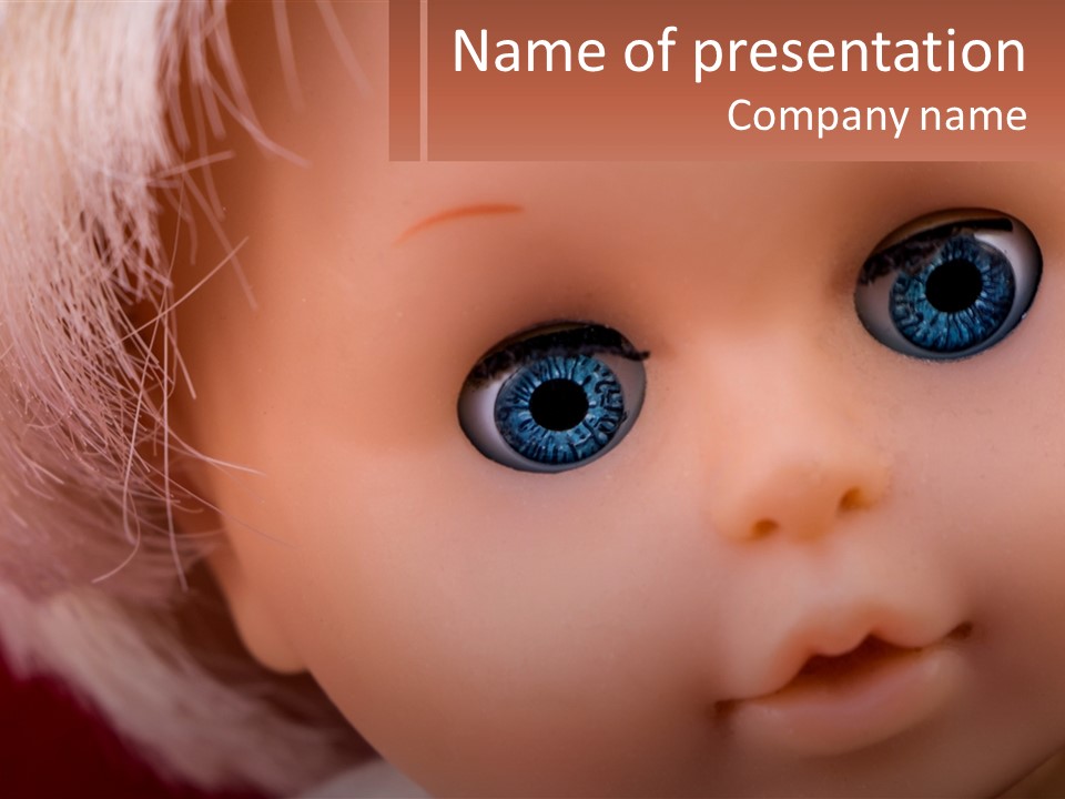 A Close Up Of A Doll With Blue Eyes PowerPoint Template