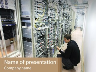 A Man Sitting On The Floor In Front Of A Server PowerPoint Template