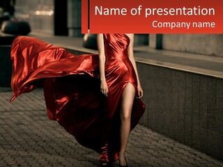 A Woman In A Red Dress Is Walking Down The Street PowerPoint Template