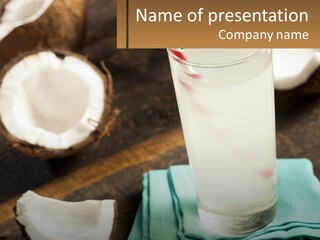 A Glass Of Water Next To Some Coconuts On A Table PowerPoint Template