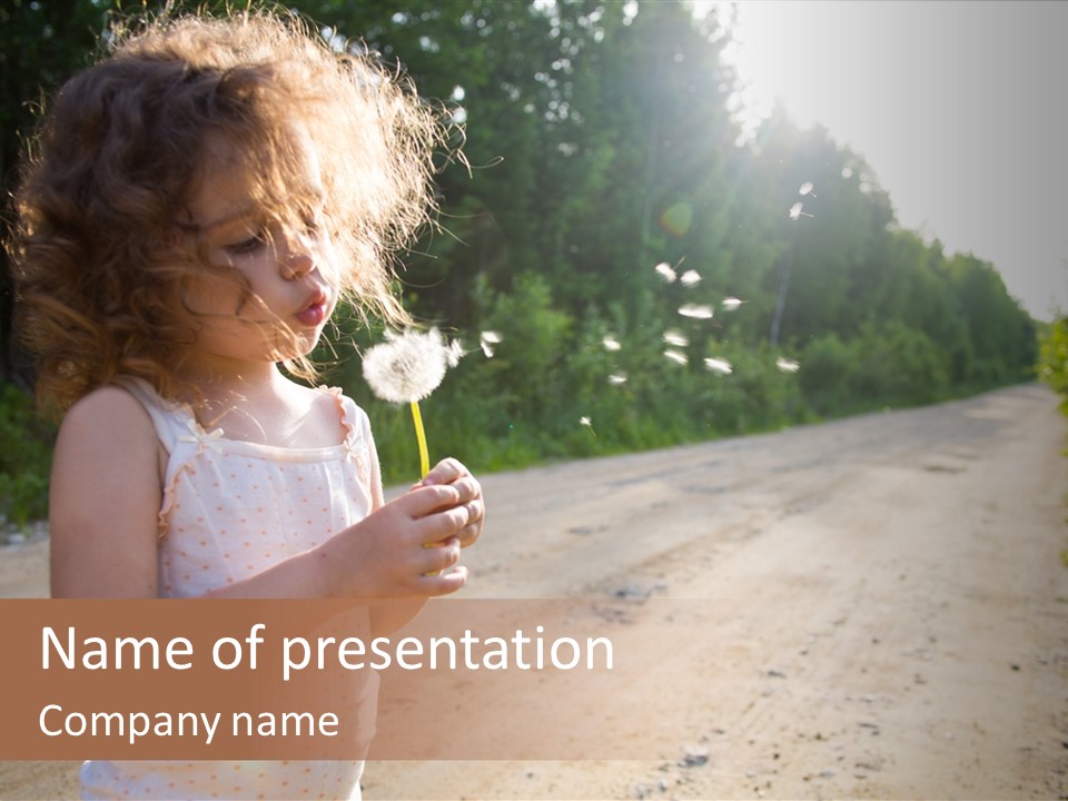 A Little Girl Blowing A Dandelion On A Dirt Road PowerPoint Template